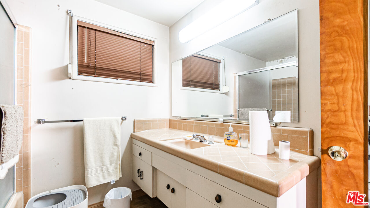 1408 251st Street Harbor City, CA 90710 - Photo 19 of 40 a bathroom with a sink vanity granite and a mirror