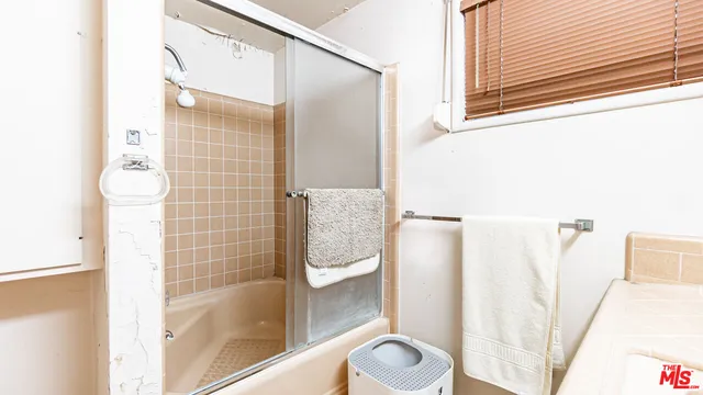 a en suite bathroom with a sink a mirror and a shower