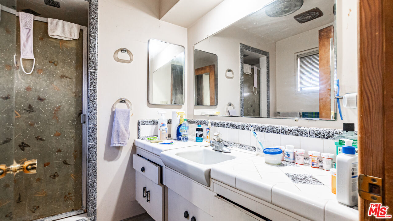 1408 251st Street Harbor City, CA 90710 - Photo 23 of 40 a en suite bathroom with a sink a mirror and a shower