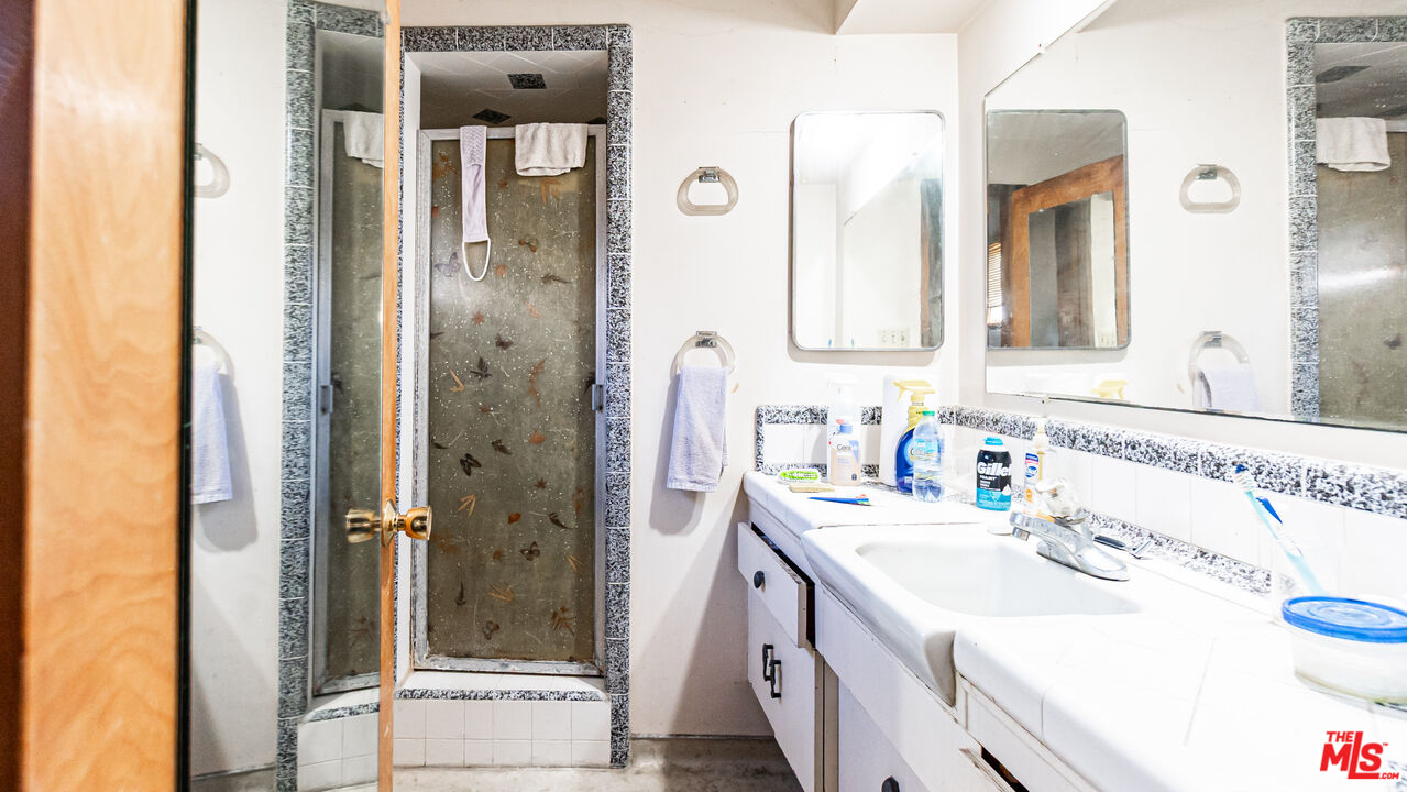 1408 251st Street Harbor City, CA 90710 - Photo 24 of 40 a bathroom with a sink vanity granite shower and a mirror