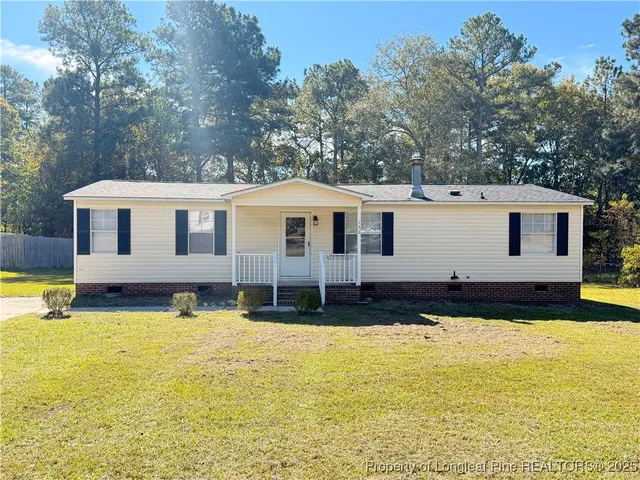 a view of a house with swimming pool and a yard