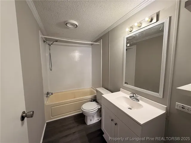 a bathroom with a sink toilet tub and shower
