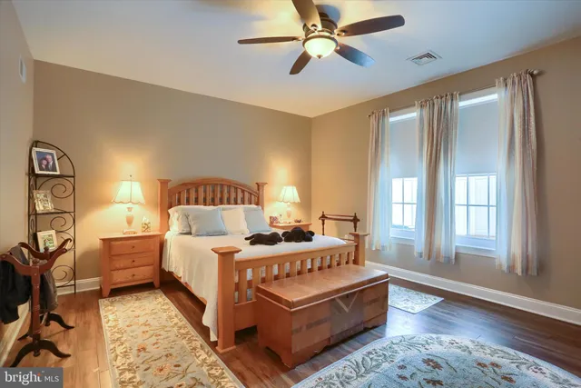 a bedroom with a bed lamp and a large window