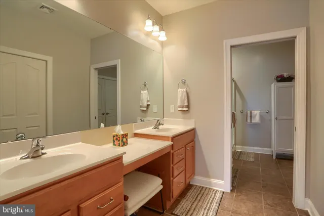 a bathroom with a sink double vanity and a mirror
