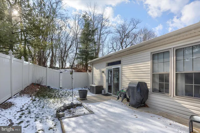 a view of backyard with a barn and a large tree