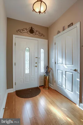 a view of a livingroom with wooden floor and a bathroom