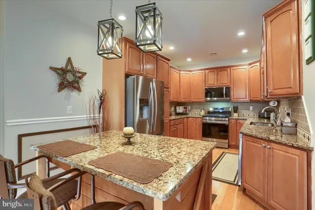 a kitchen with refrigerator cabinets dining table and chairs