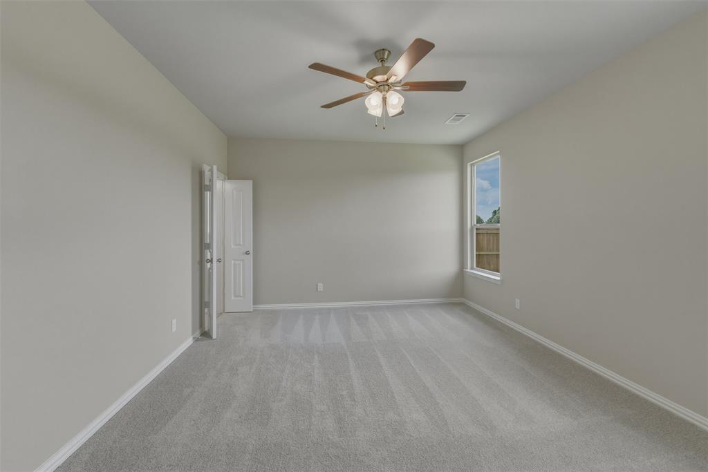 1232 Colca Drive Springtown, TX 76082 - Photo 11 of 23 Spacious room featuring neutral carpeting, light-toned walls, and a ceiling fan with integrated lighting