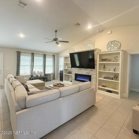 a living room with furniture and a flat screen tv