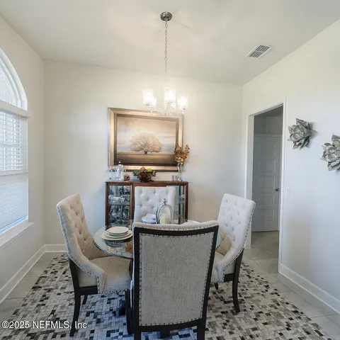 a dining room with furniture and window