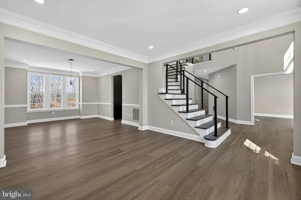 a large kitchen with stainless steel appliances kitchen island granite countertop a large stove a sink dishwasher and a microwave oven with wooden floor