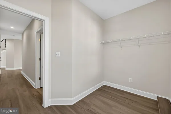 an empty room with windows and closet