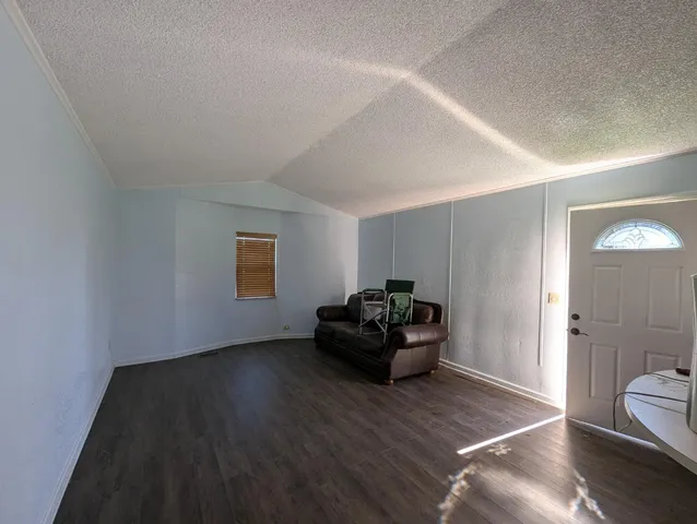 a kitchen with a refrigerator and a stove top oven