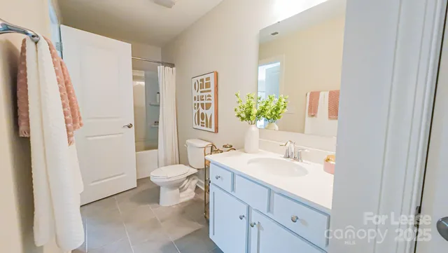 a bathroom with a double vanity sink toilet and shower