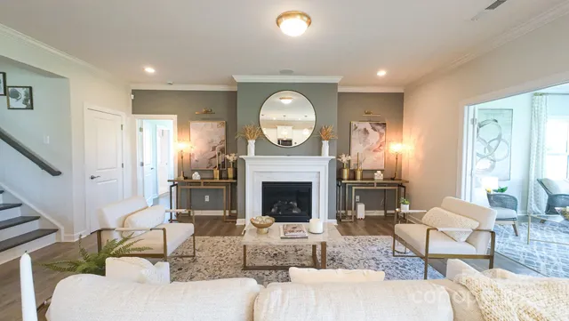 a living room with furniture a fireplace and a large window