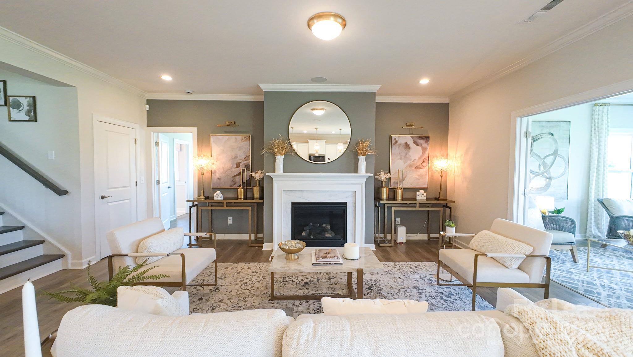 1018 Stone Marker Drive Monroe, NC 28112 - Photo 3 of 24 a living room with furniture a fireplace and a large window