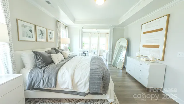 a bedroom with a bed and a large window