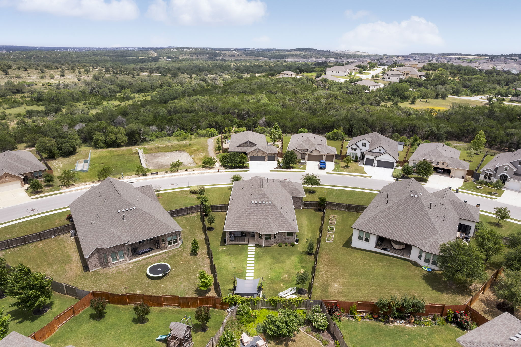 772 Founders Ridge Dripping Springs, TX 78620 - Photo 34 of 40 Aerial views showcase the home’s positioning directly across from protected green space and Hill Country surroundings.