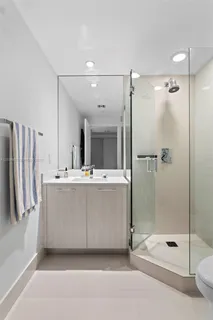 a bathroom with a tub sink shower and mirror