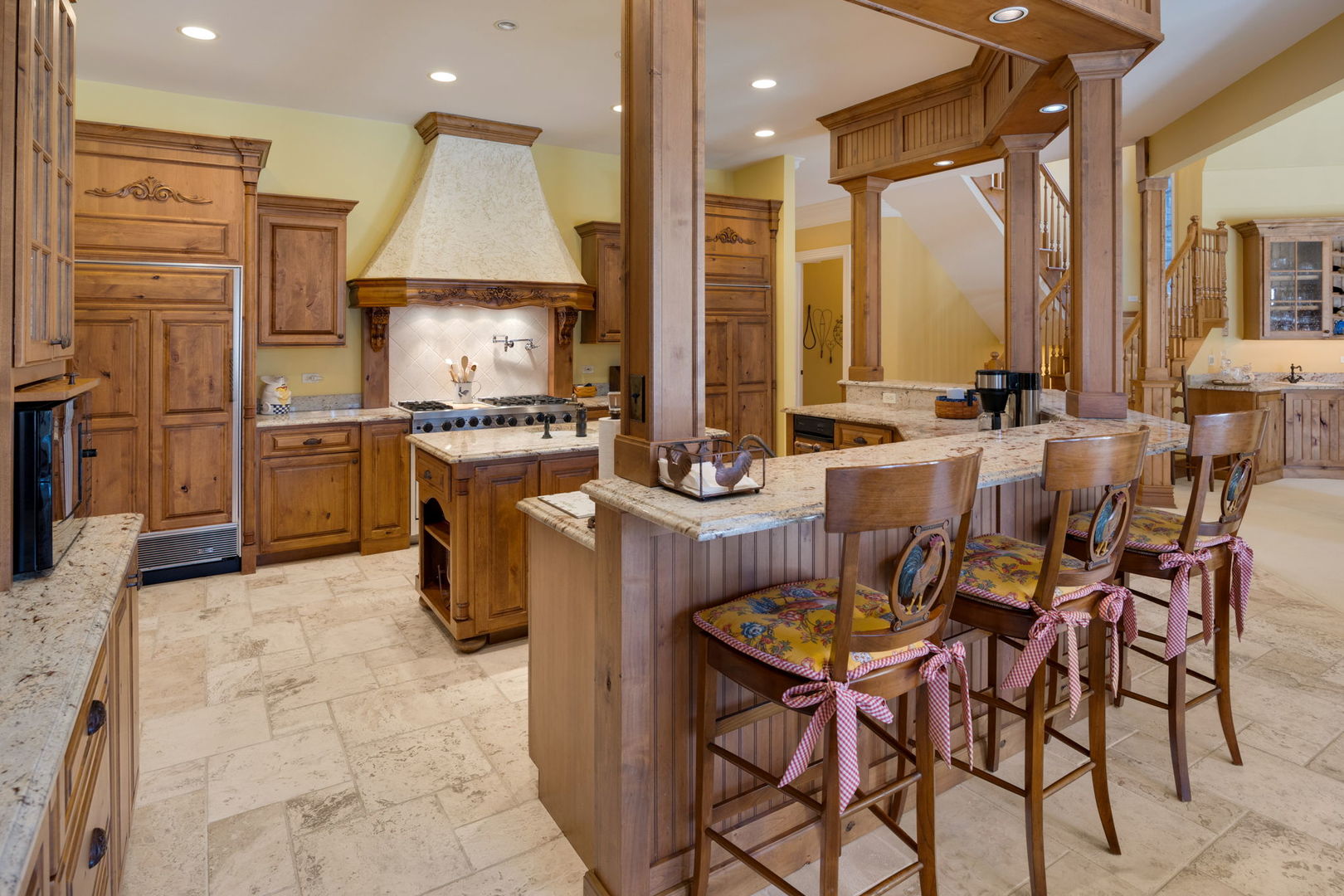 33W551 Hub Road Wayne, IL 60184 - Photo 19 of 59 a kitchen with stainless steel appliances granite countertop a stove top oven dining table chairs and a refrigerator