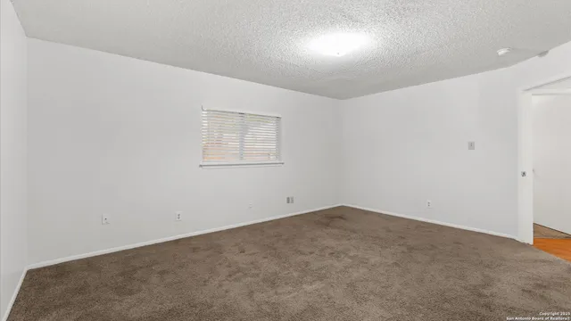 an empty room with a empty space and windows