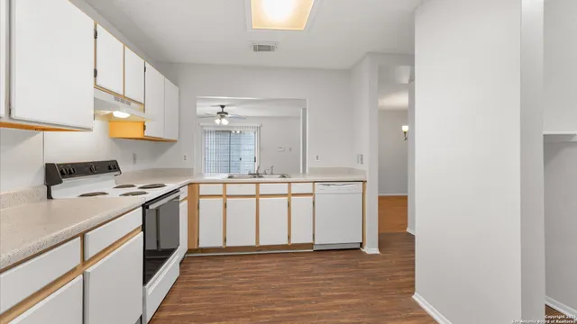a kitchen with stainless steel appliances a white stove top oven and a refrigerator