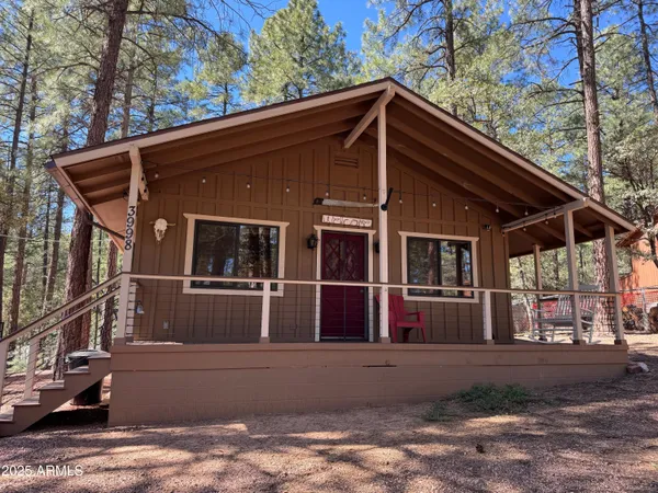 a open kitchen with stainless steel appliances kitchen island granite countertop a table chairs and a refrigerator