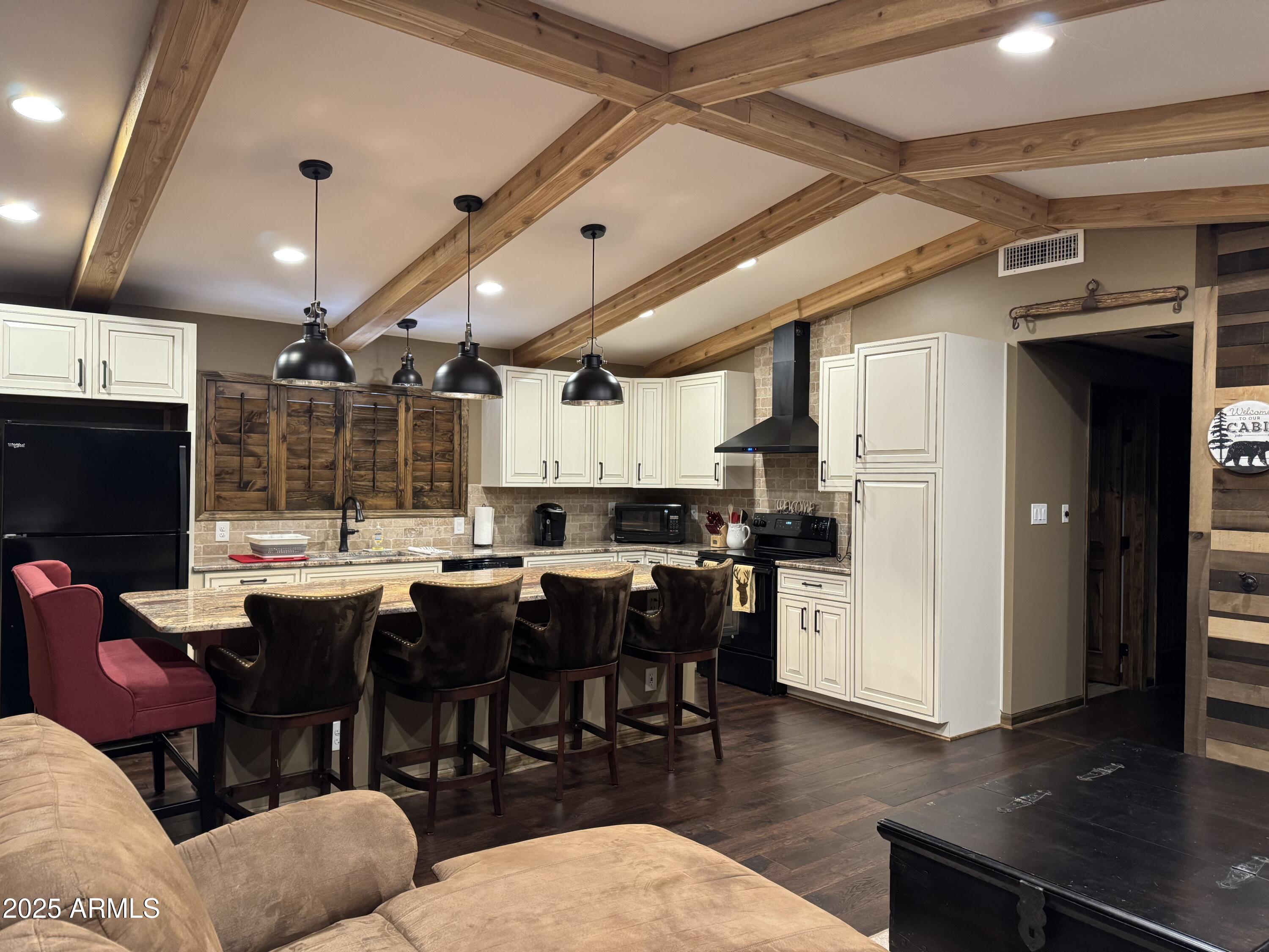 3998 Bloody Basin Road Pine, AZ 85544 - Photo 2 of 71 a open kitchen with stainless steel appliances kitchen island granite countertop a table chairs and a refrigerator