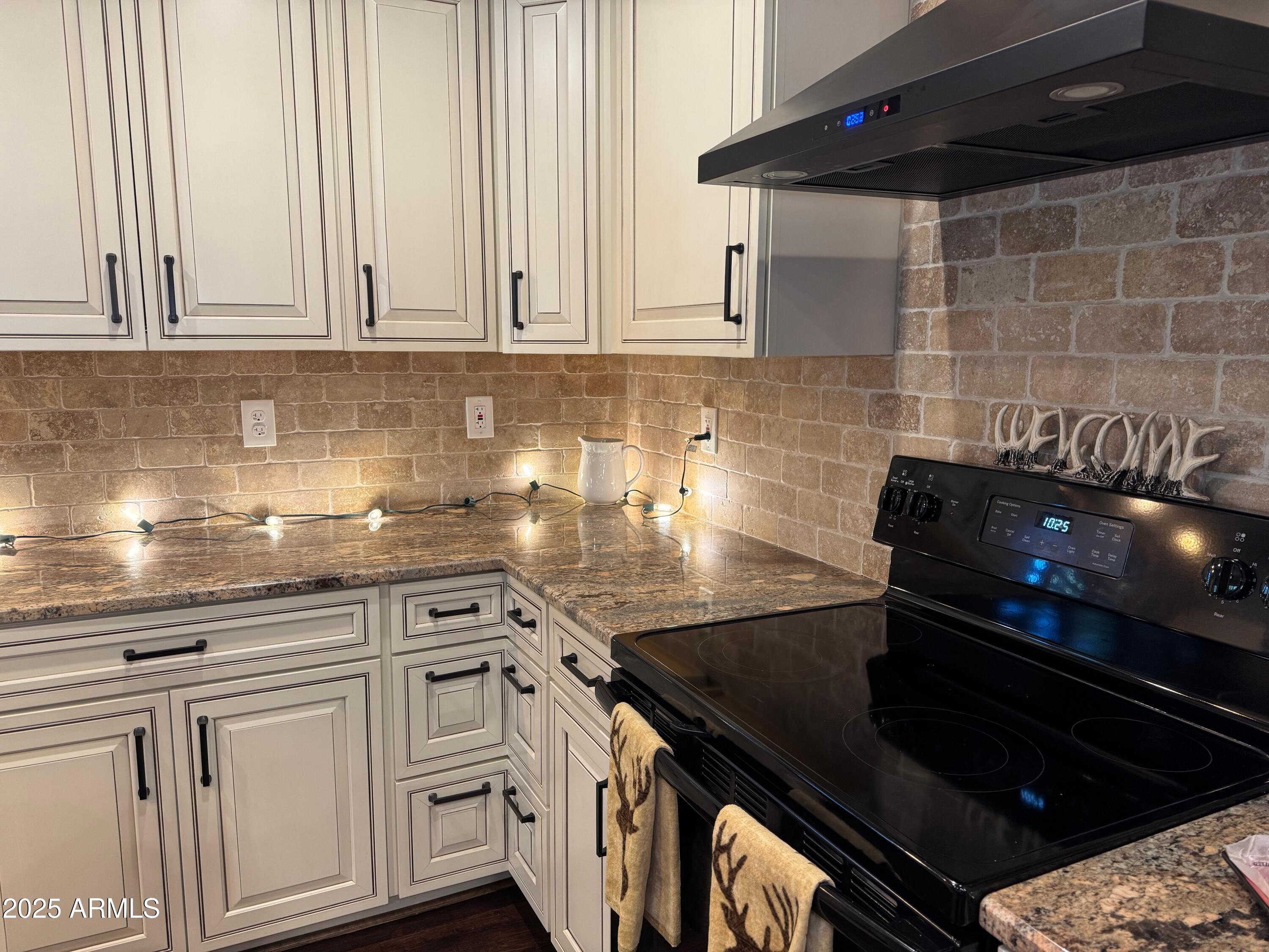 3998 Bloody Basin Road Pine, AZ 85544 - Photo 35 of 71 a kitchen with white cabinets and appliances