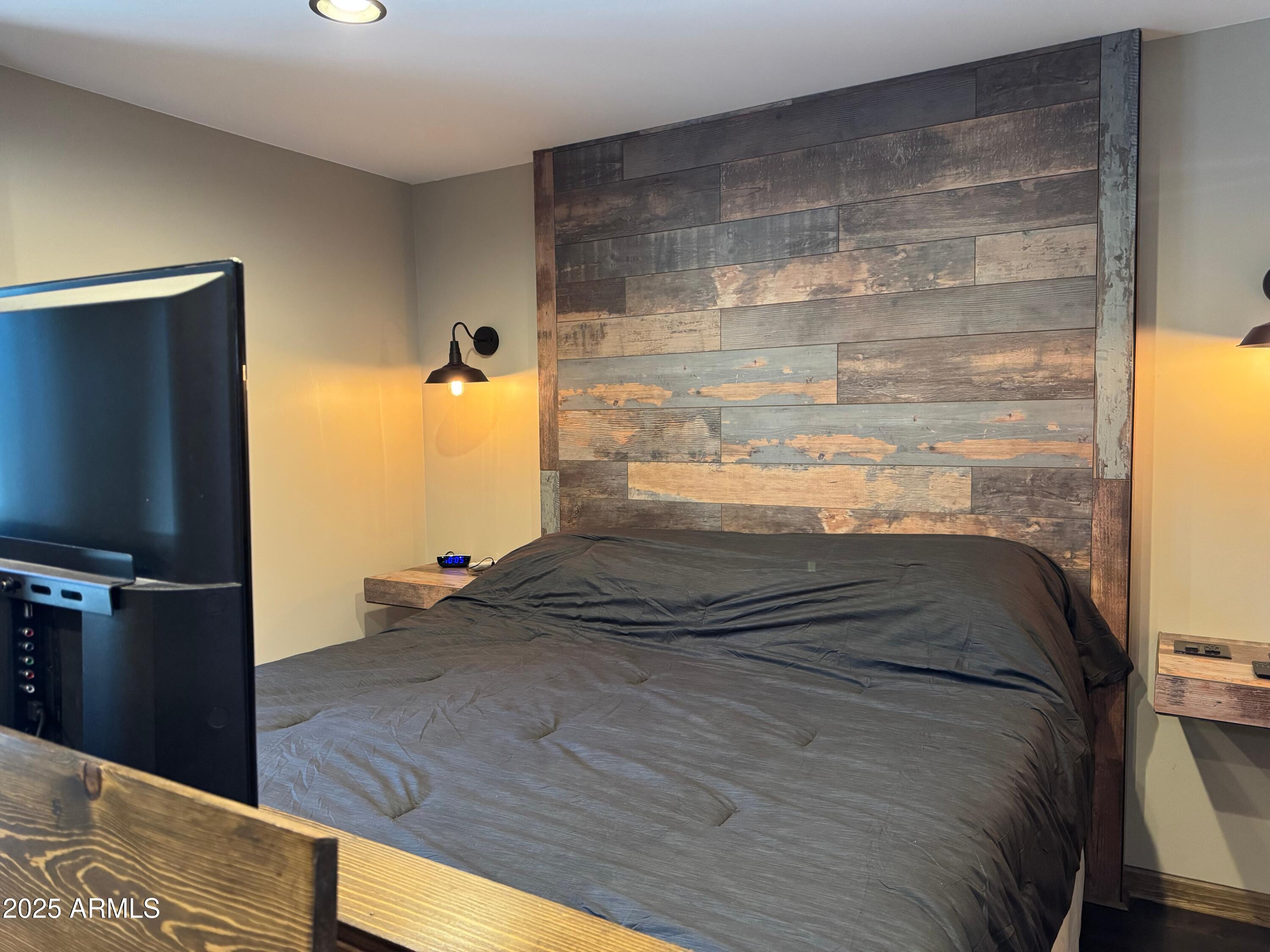 3998 Bloody Basin Road Pine, AZ 85544 - Photo 49 of 71 a bedroom with a bed and a flat screen tv