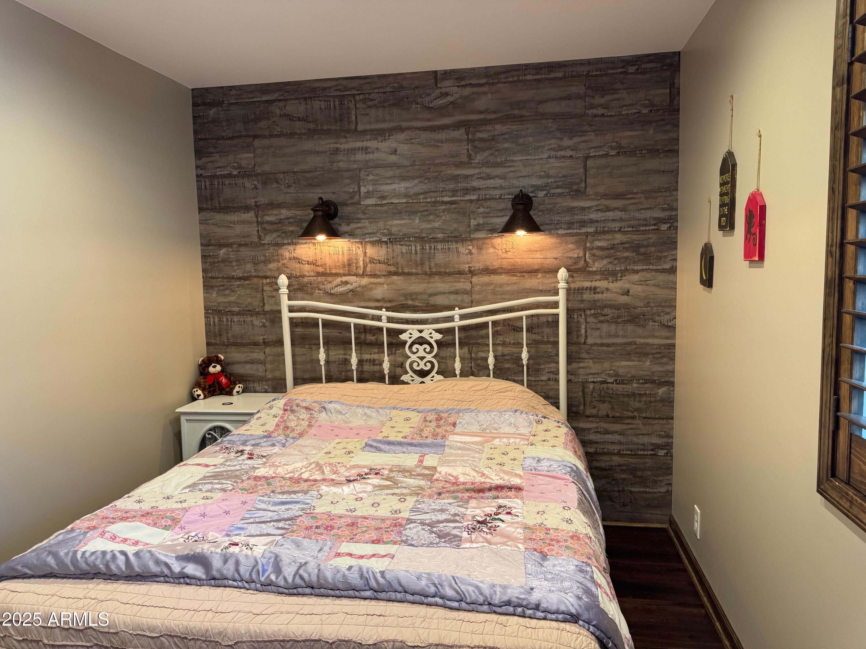 3998 Bloody Basin Road Pine, AZ 85544 - Photo 52 of 71 a bedroom with a bed and a chandelier