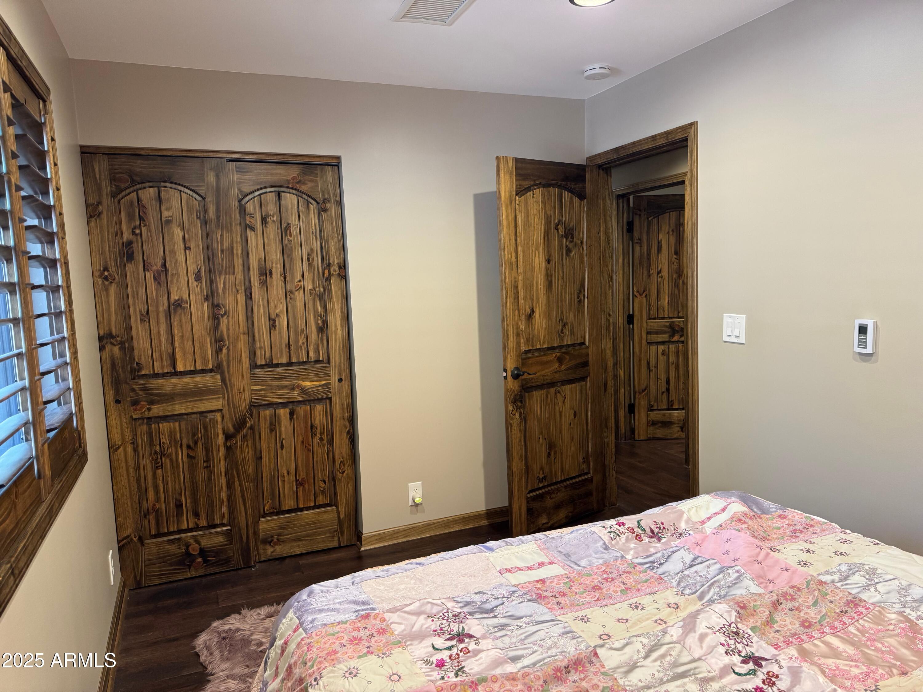 3998 Bloody Basin Road Pine, AZ 85544 - Photo 53 of 71 a bedroom with a bed and wooden floor