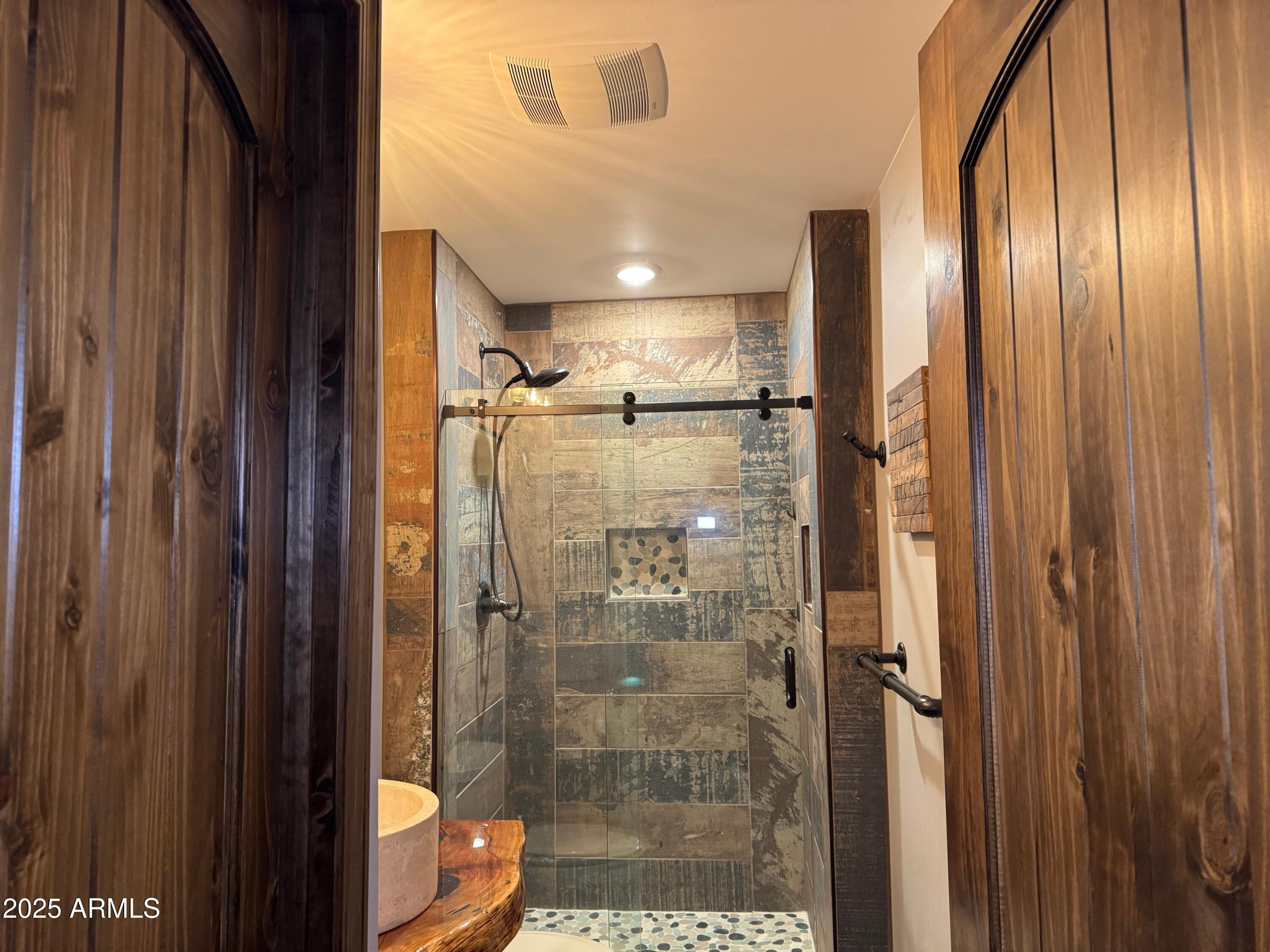 3998 Bloody Basin Road Pine, AZ 85544 - Photo 63 of 71 a bathroom with a glass shower door