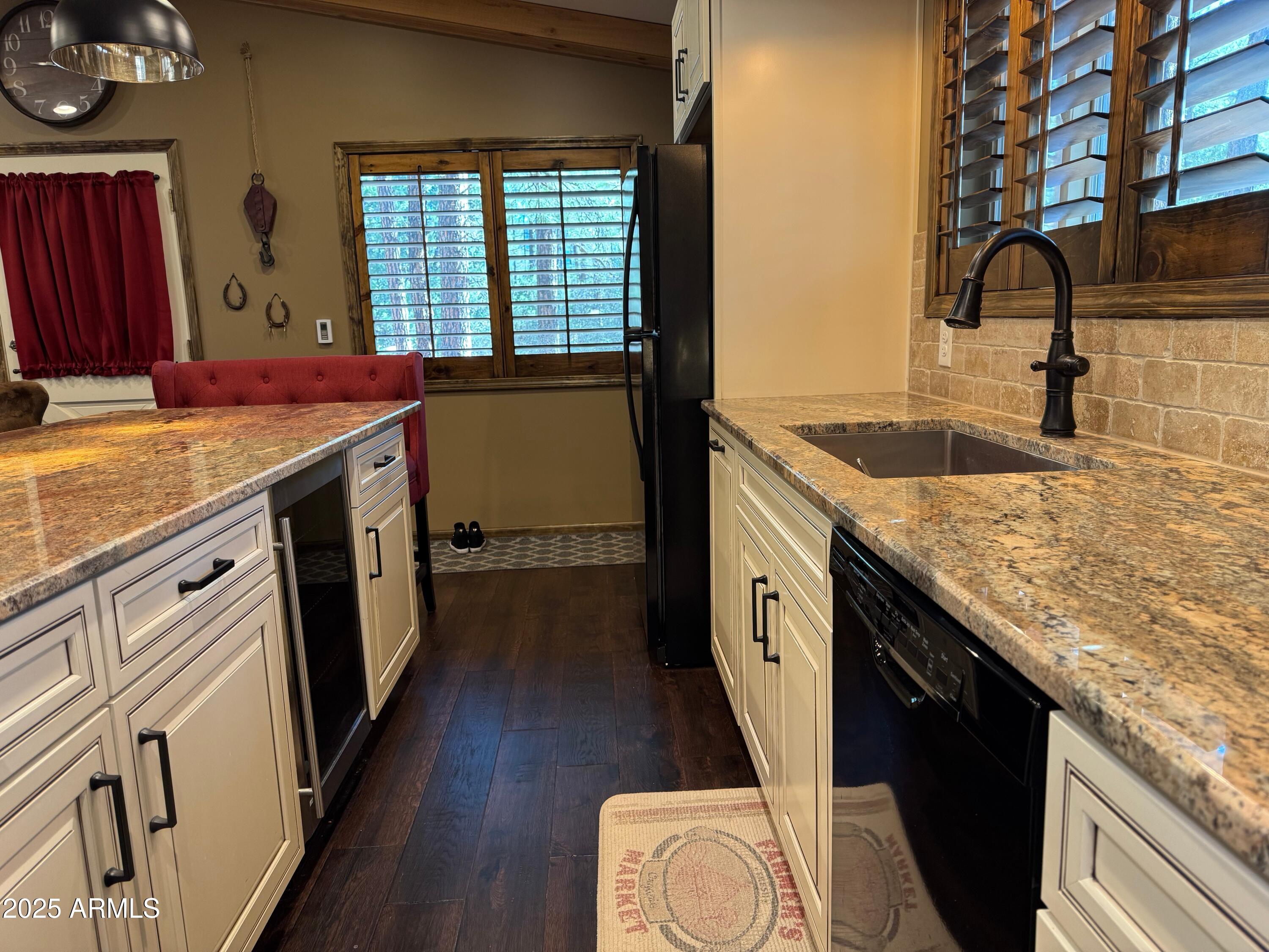 3998 Bloody Basin Road Pine, AZ 85544 - Photo 68 of 71 a kitchen with granite countertop a sink stove and cabinets