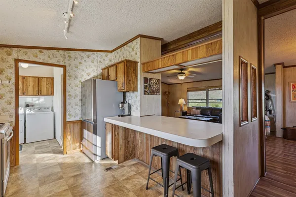 a bedroom with furniture and a large window