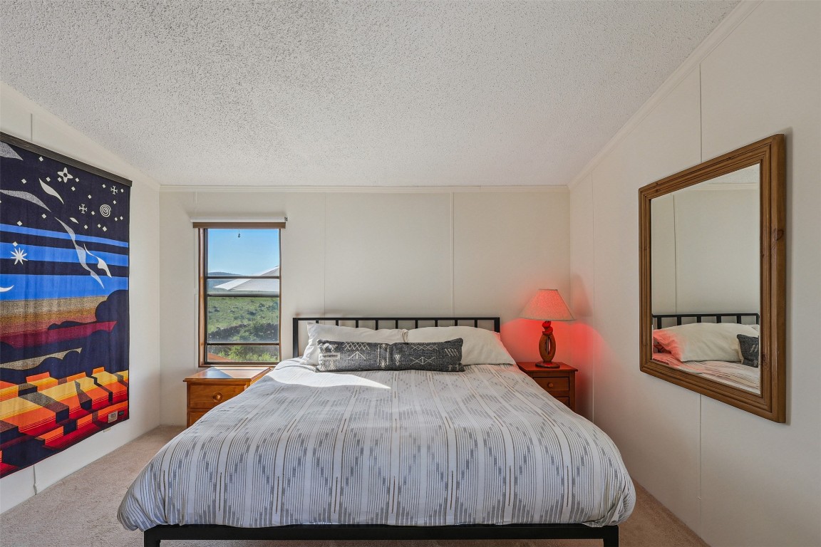 106 Ridge Line Drive Fort Davis, TX 79734 - Photo 16 of 39 a bedroom with a bed and window