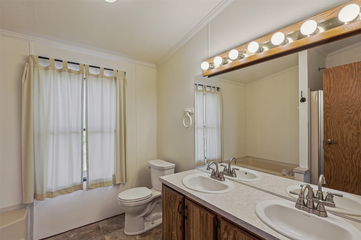 106 Ridge Line Drive Fort Davis, TX 79734 - Photo 18 of 39 a bathroom with a double vanity sink mirror and toilet