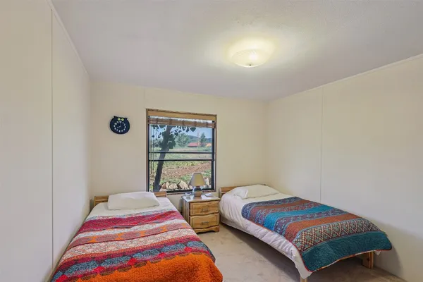 a bedroom with a bed and a painting on the wall