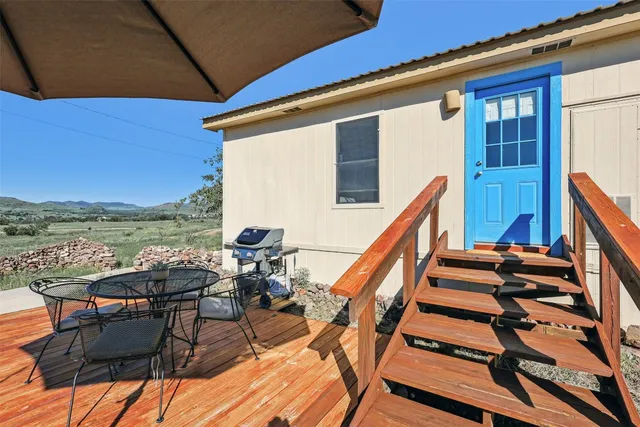 a blue swimming pool with outdoor seating and yard