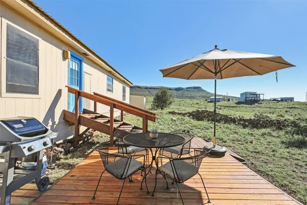a view of a terrace with furniture and table