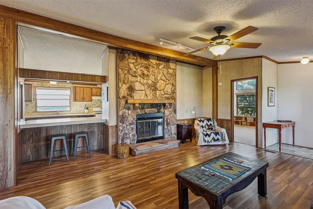 a living room with fireplace furniture and a wooden floor