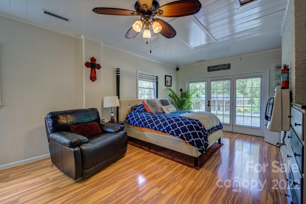 292 Brookside Camp Road Hendersonville, NC 28792 - Photo 17 of 41 a bedroom with a bed couch and a large window