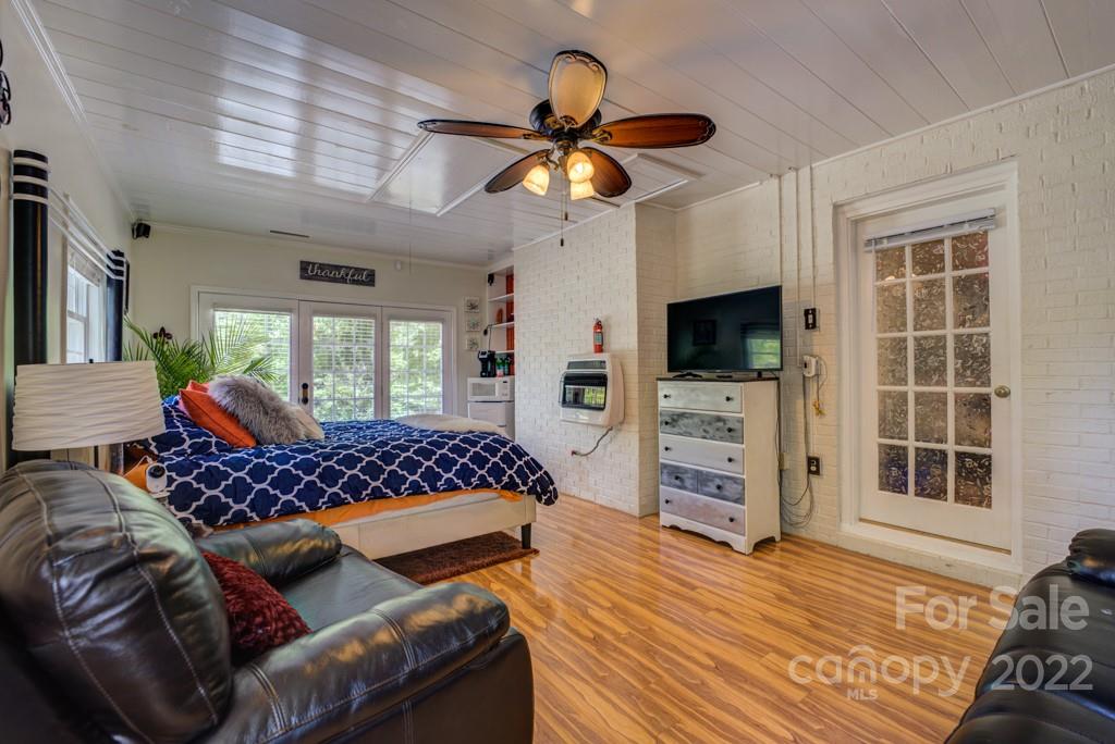 292 Brookside Camp Road Hendersonville, NC 28792 - Photo 18 of 41 a bedroom with furniture and a flat screen tv