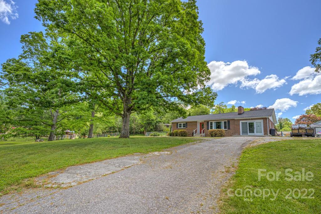 292 Brookside Camp Road Hendersonville, NC 28792 - Photo 25 of 41 a view of a house with a big yard
