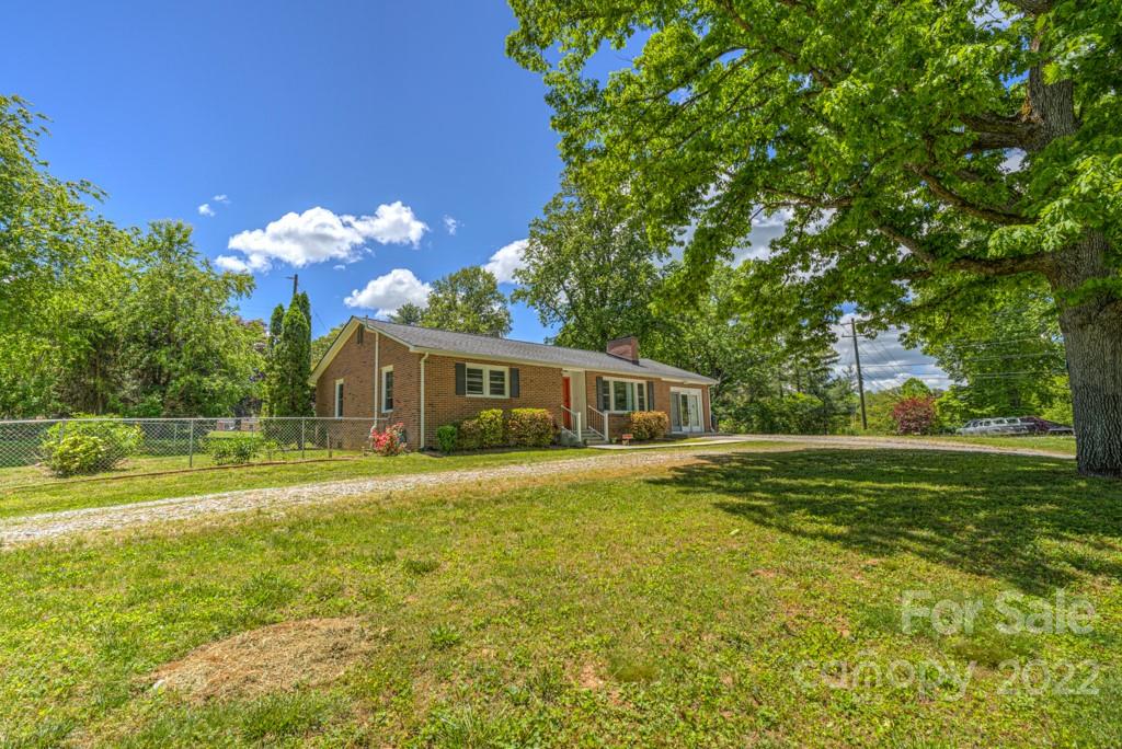 292 Brookside Camp Road Hendersonville, NC 28792 - Photo 27 of 41 a front view of a house with a big yard