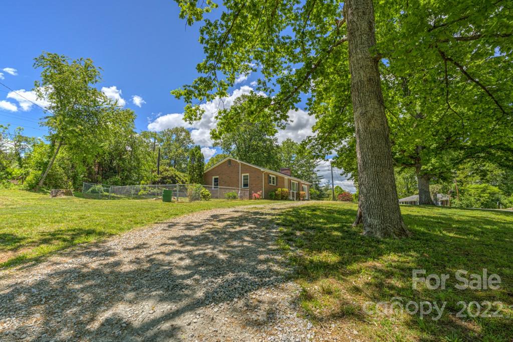 292 Brookside Camp Road Hendersonville, NC 28792 - Photo 28 of 41 a view of a house with a yard