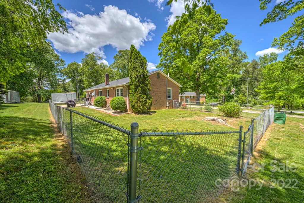 292 Brookside Camp Road Hendersonville, NC 28792 - Photo 31 of 41 a view of an house with backyard and swimming pool