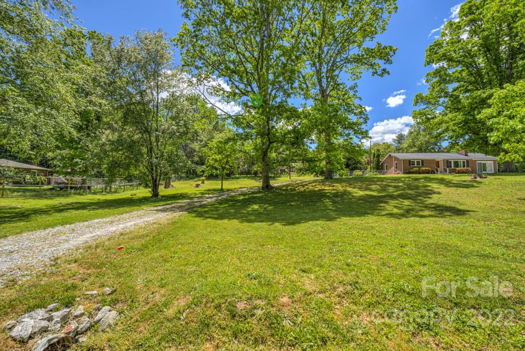 292 Brookside Camp Road Hendersonville, NC 28792 - Photo 35 of 41 a view of a green field with trees in the background