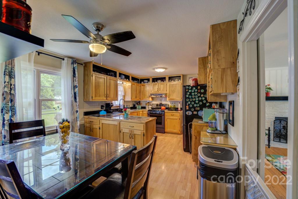 292 Brookside Camp Road Hendersonville, NC 28792 - Photo 5 of 41 a very nice looking dining room with a large window and stainless steel appliances