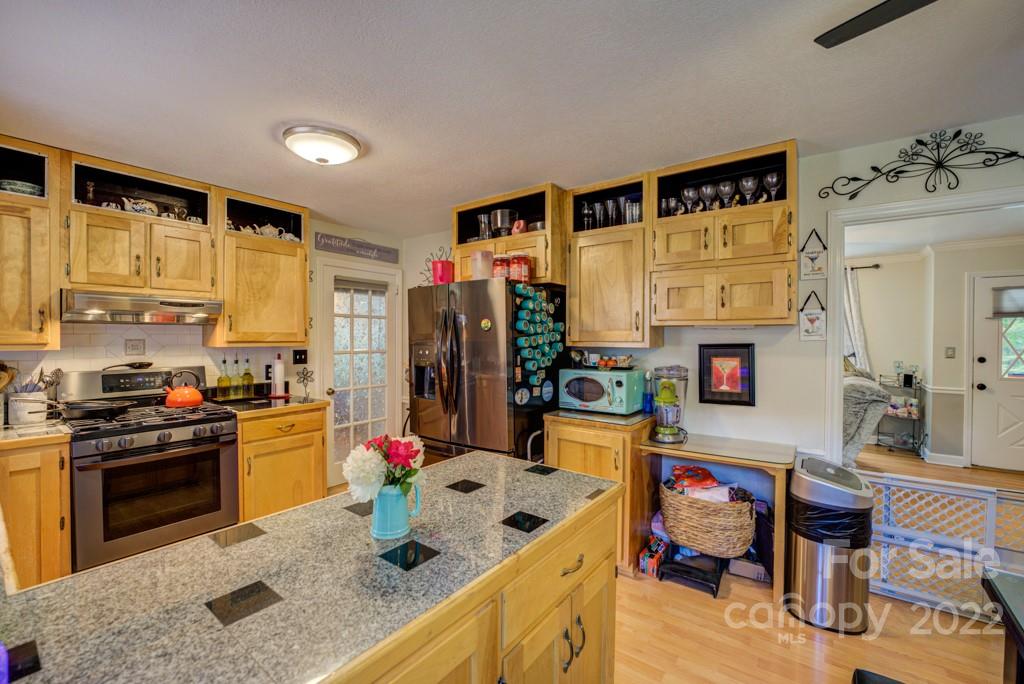 292 Brookside Camp Road Hendersonville, NC 28792 - Photo 6 of 41 a kitchen that has a refrigerator and a stove in it